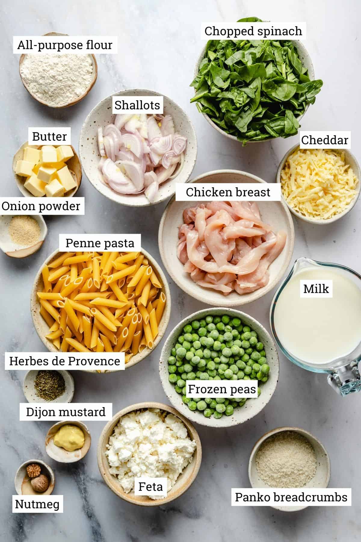 Ingredients in bowls with labels on a marble background.