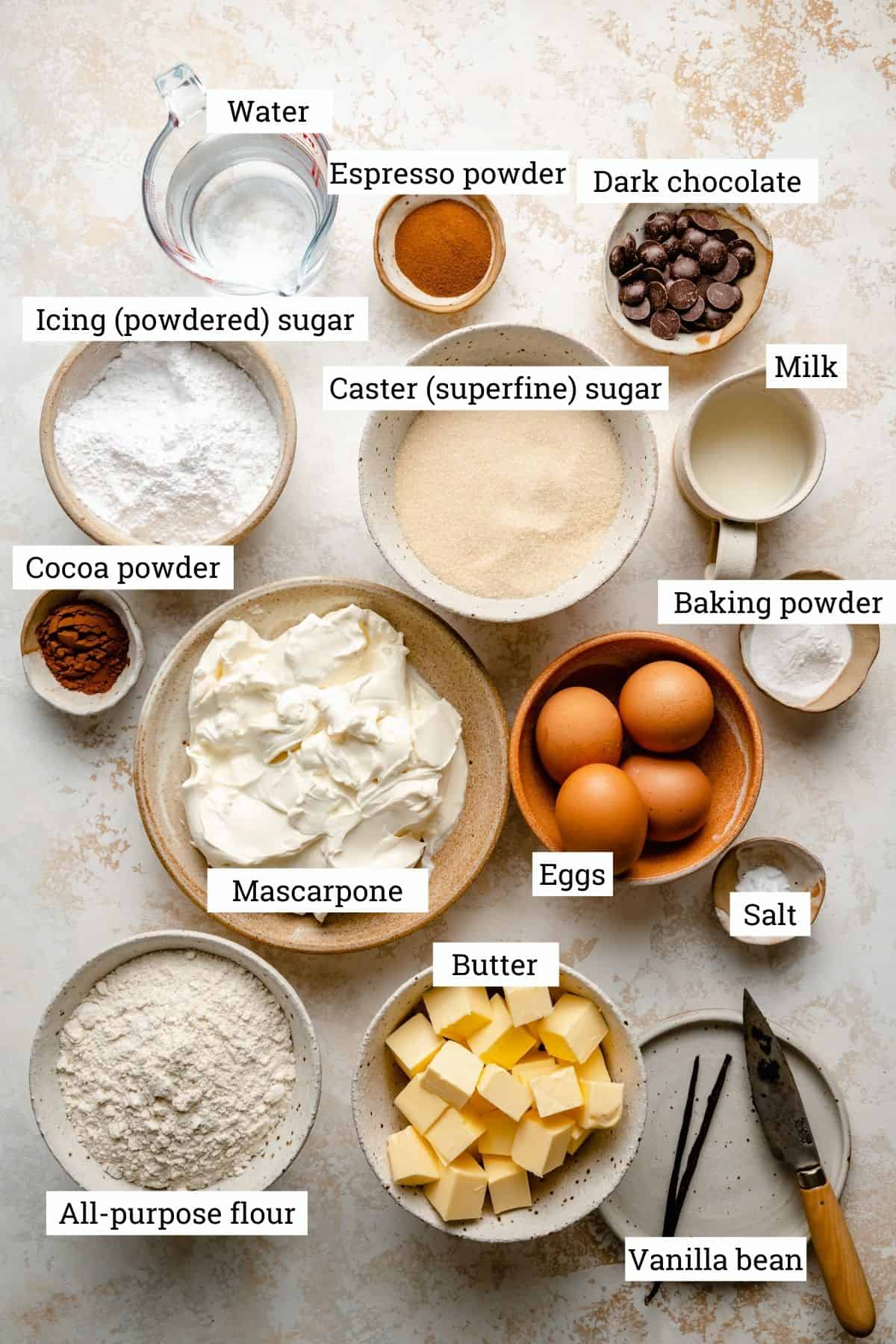 Ingredients required for tiramisu cake in various bowls labelled. 