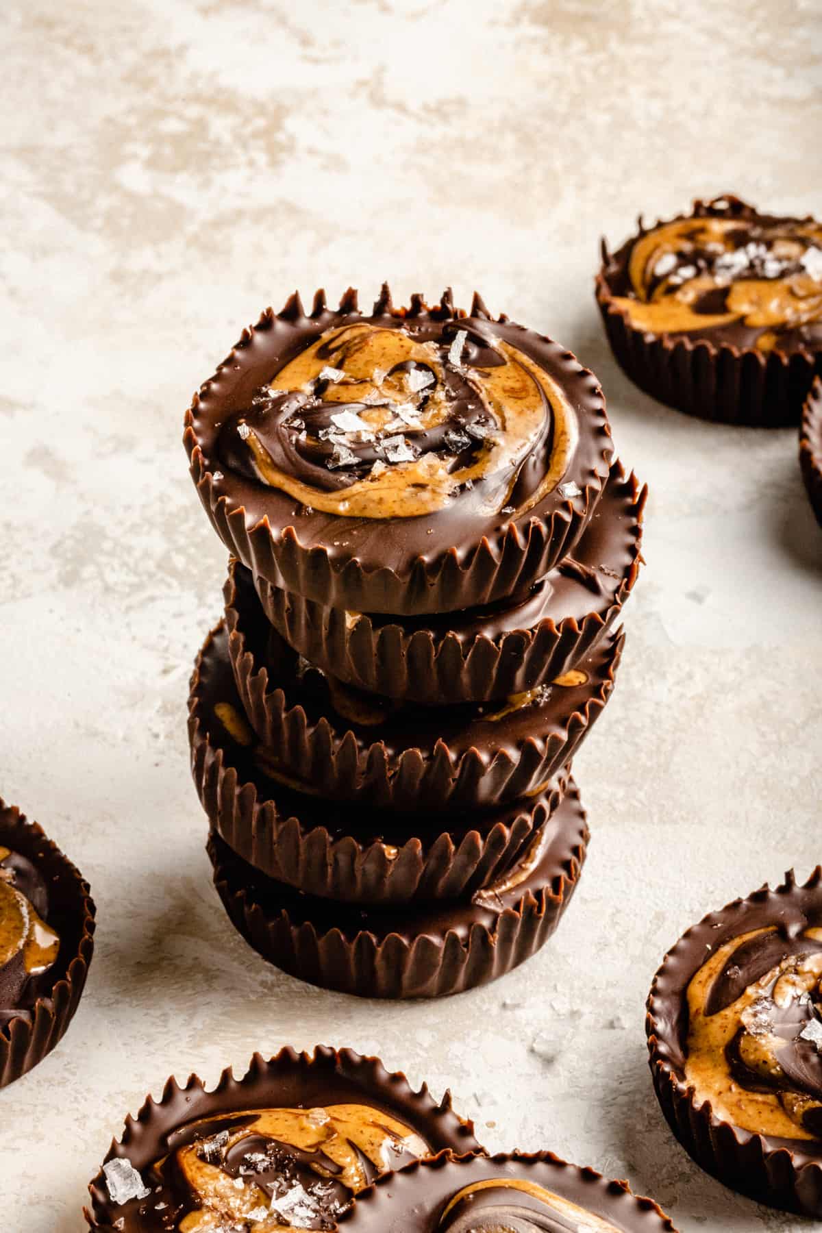 A stack of almond butter cups with salt flakes on top.