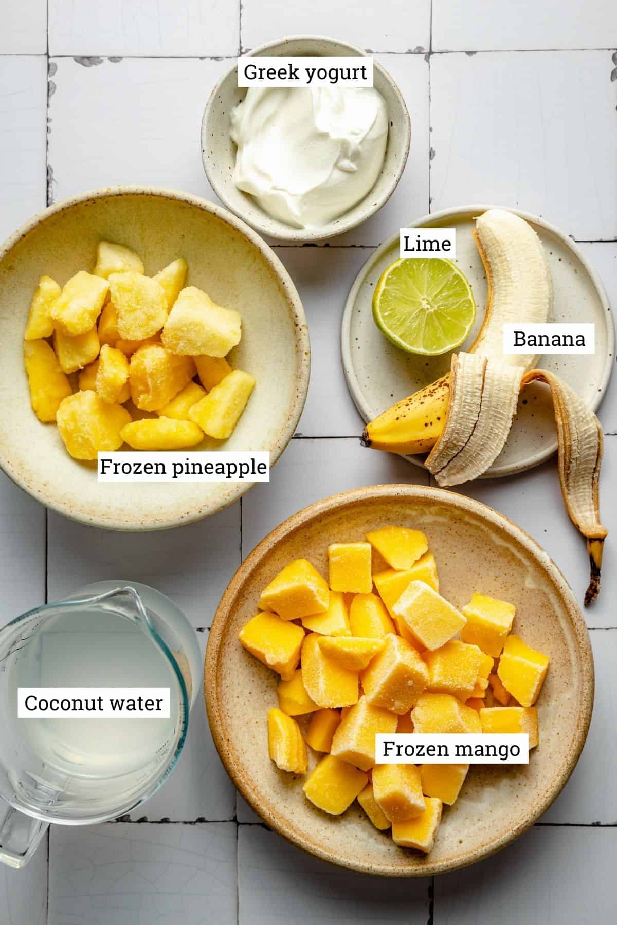 ingredients for smoothie in various bowls with labels.
