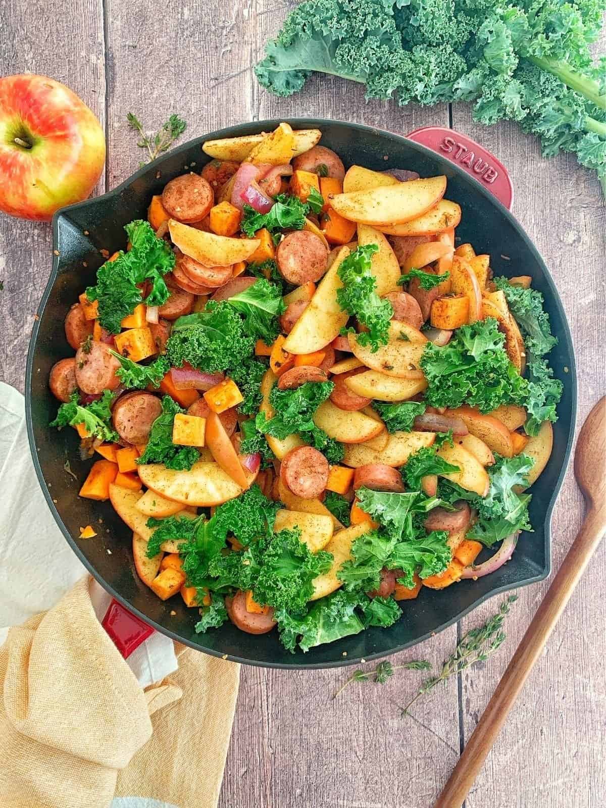 Chicken Apple Sausage Skillet with Kale with a napkin around handle.