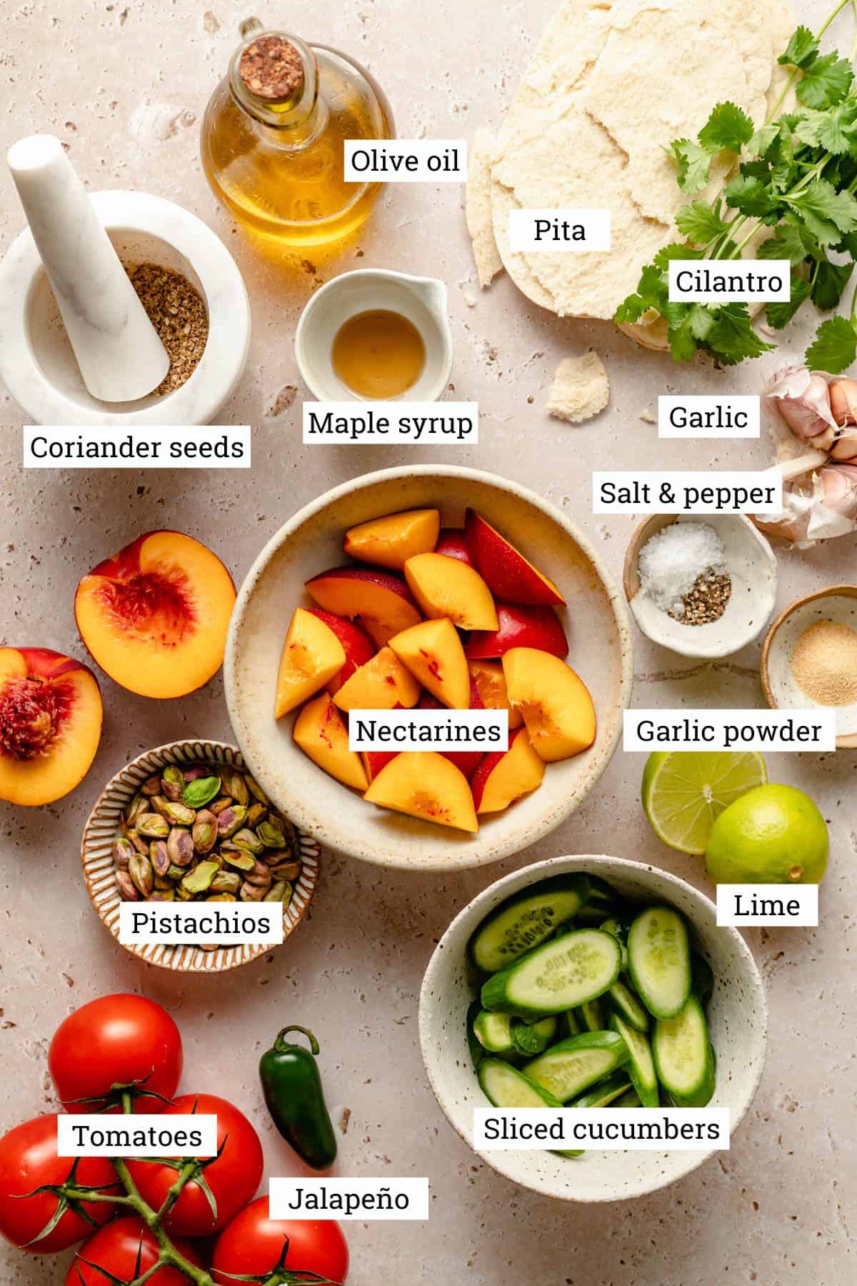 Ingredients to make nectarine salad in bowls with labels.