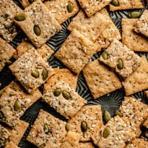 Sourdough crackers on a metal tray showing the golden brown and crispy texture.