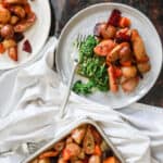 Sheet pan sausage and veggies served up on two plates.