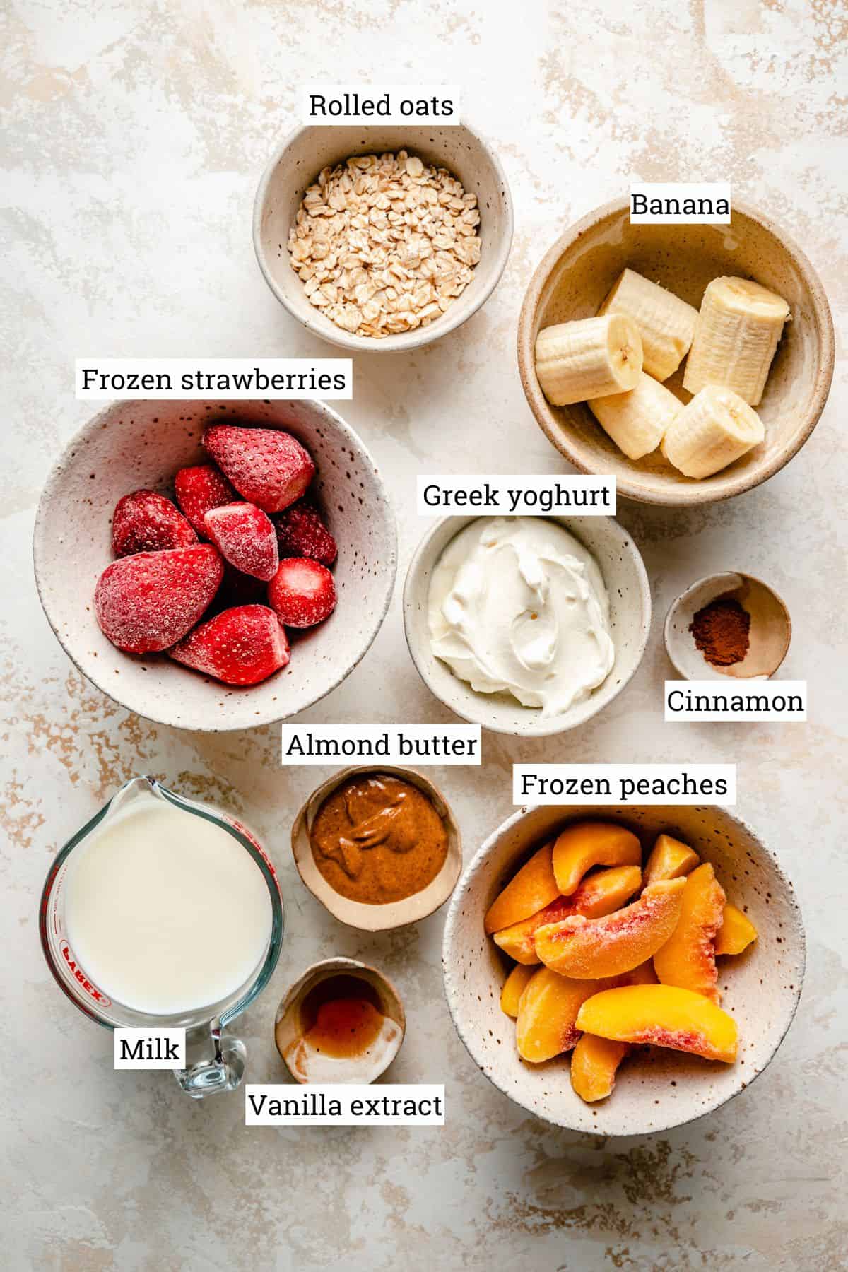 Ingredients for the smoothie in various bowls with labels. 