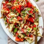 watermelon basil salad with halloumi served on a platter over a napkin.