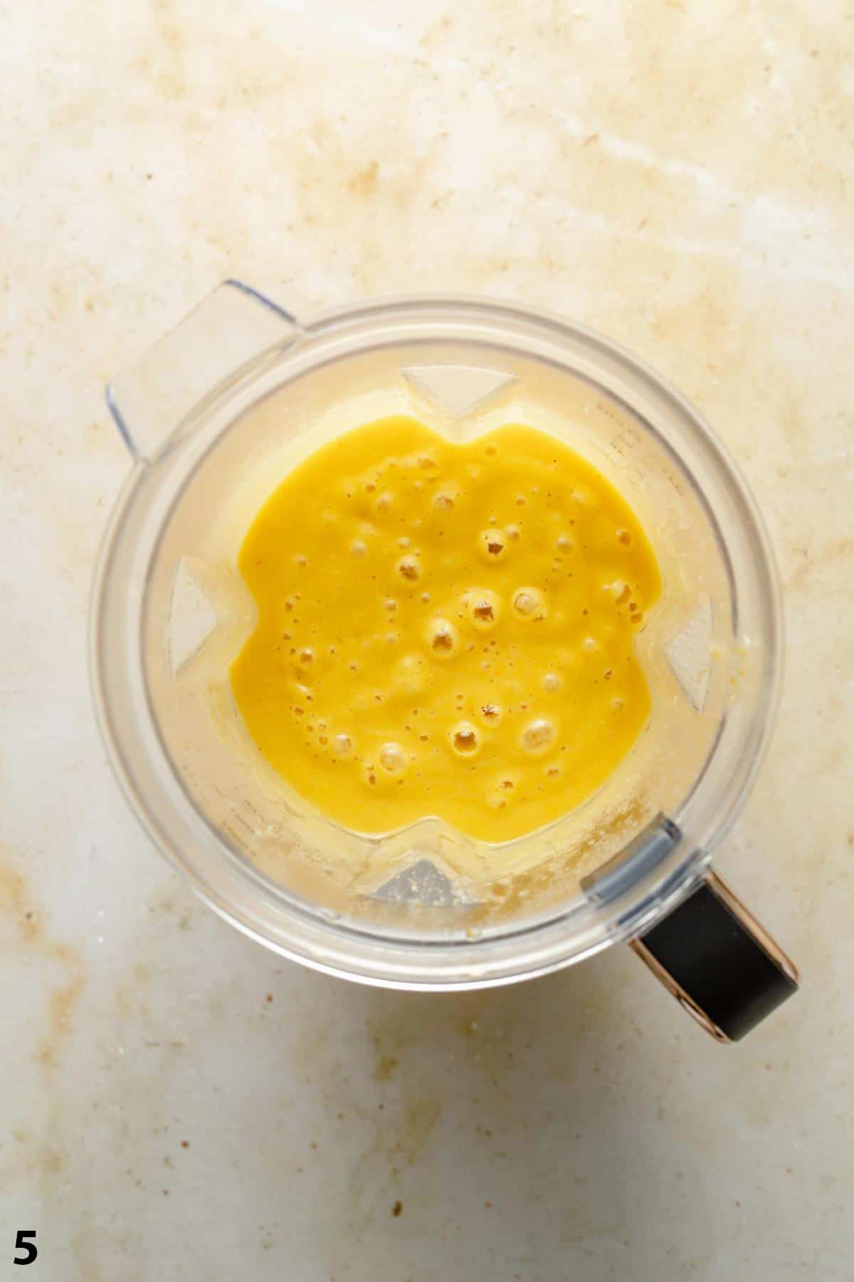 A jug of blended soup on a work surface showing how smooth it is.