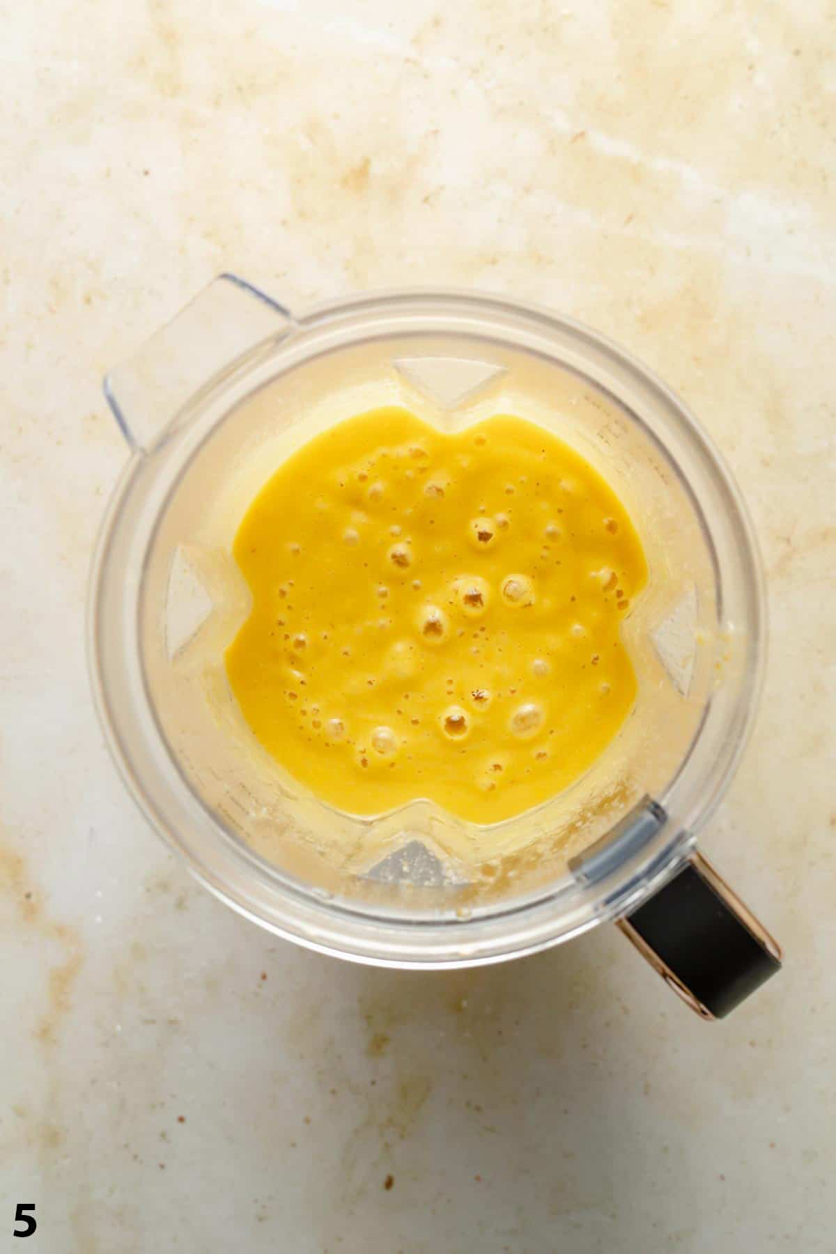 A jug of blended soup on a work surface showing how smooth it is. 