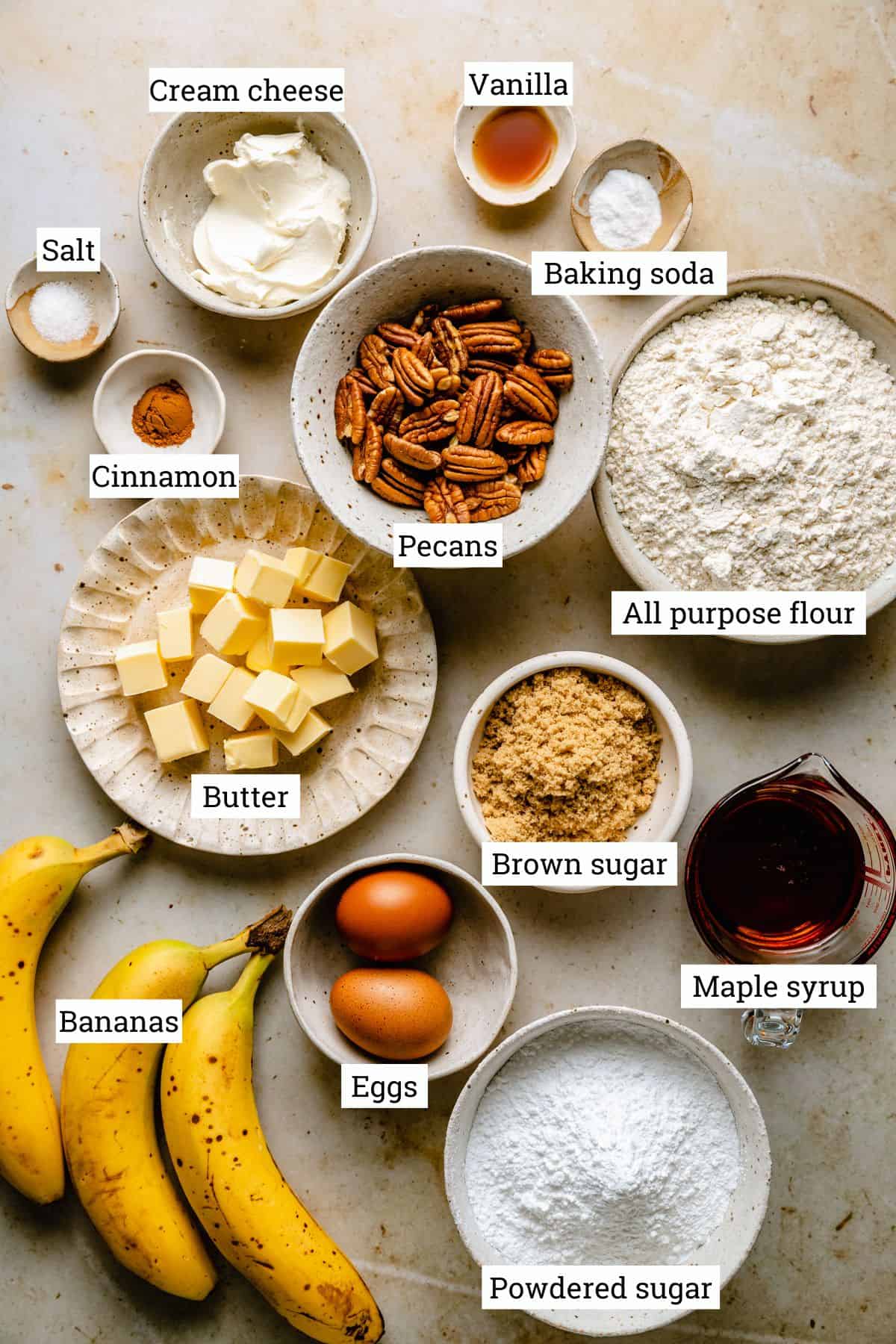 Ingredients in various bowls for banana bread with pecans.