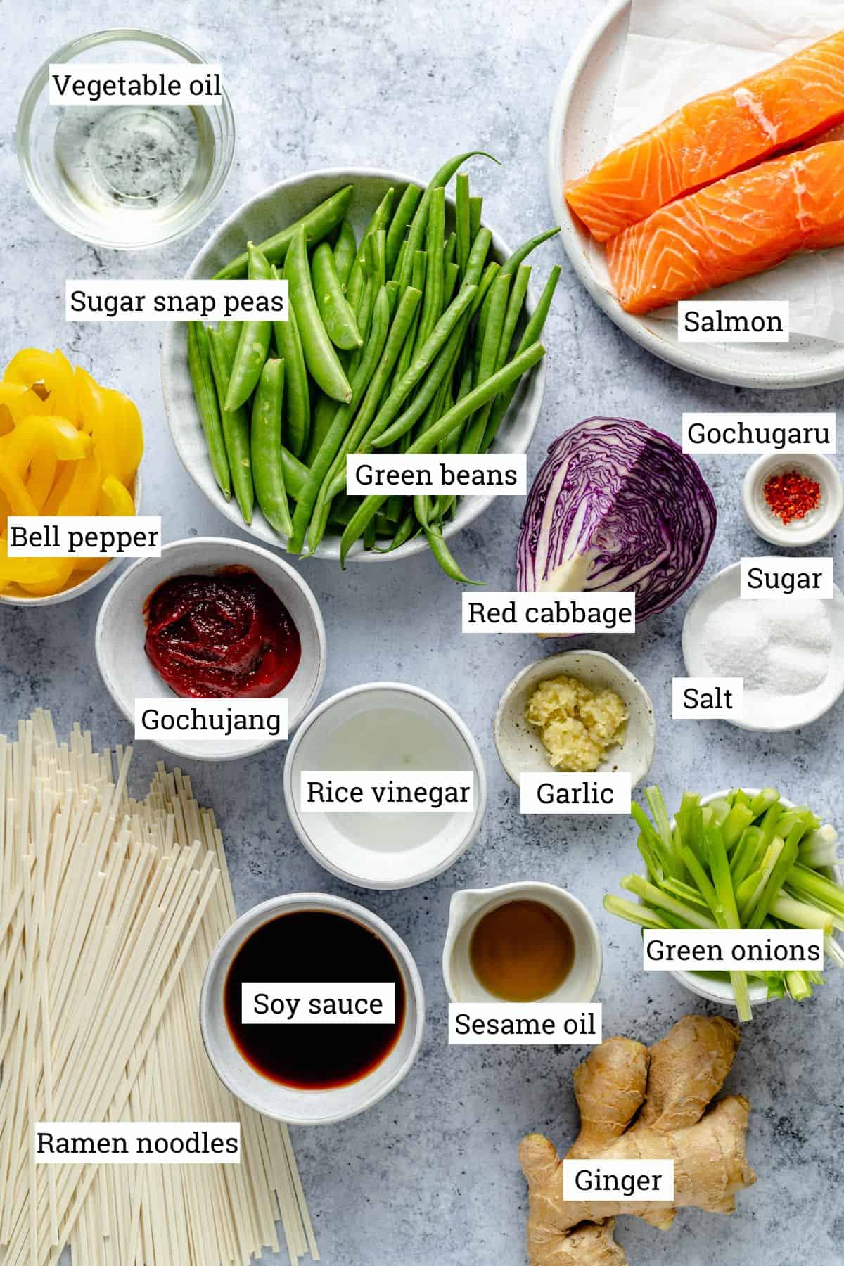Ingredients for gochujang noodles in various bowls on a work top.