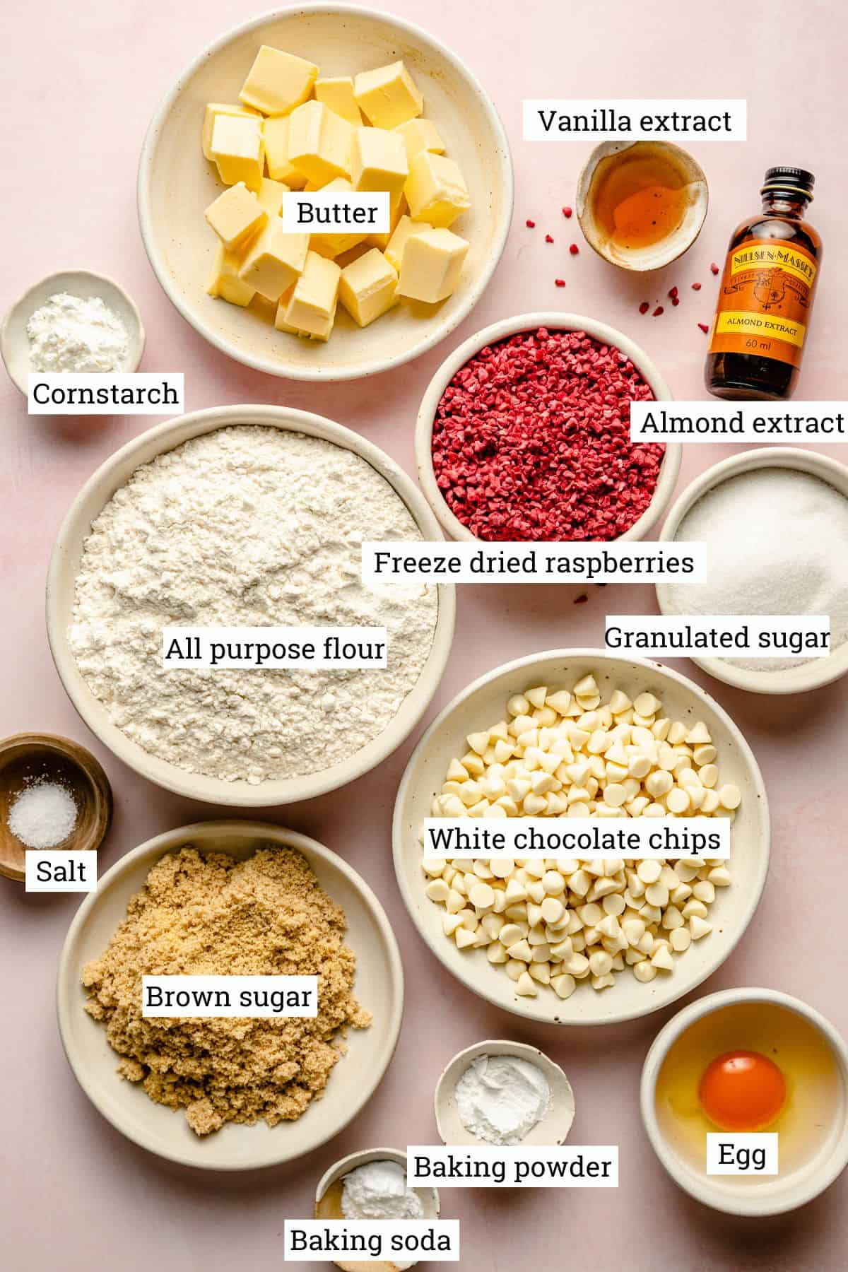 Ingredients for cookies in various bowls with labels.