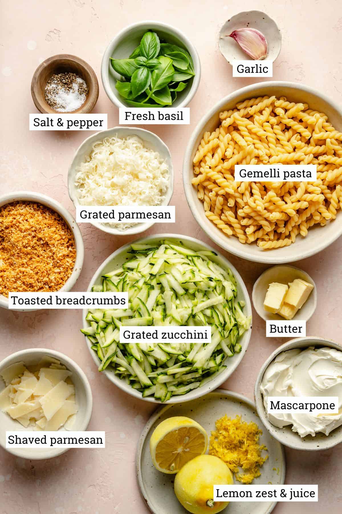 Ingredients for lemon zucchini pasta in various bowls.