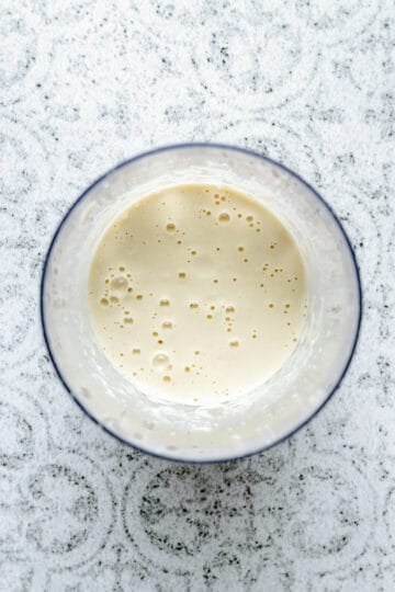Blended smooth cashew cream in a jug.